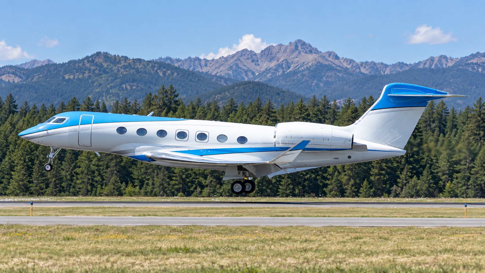 Gulfstream G600 approaching a runway with mountains behind it