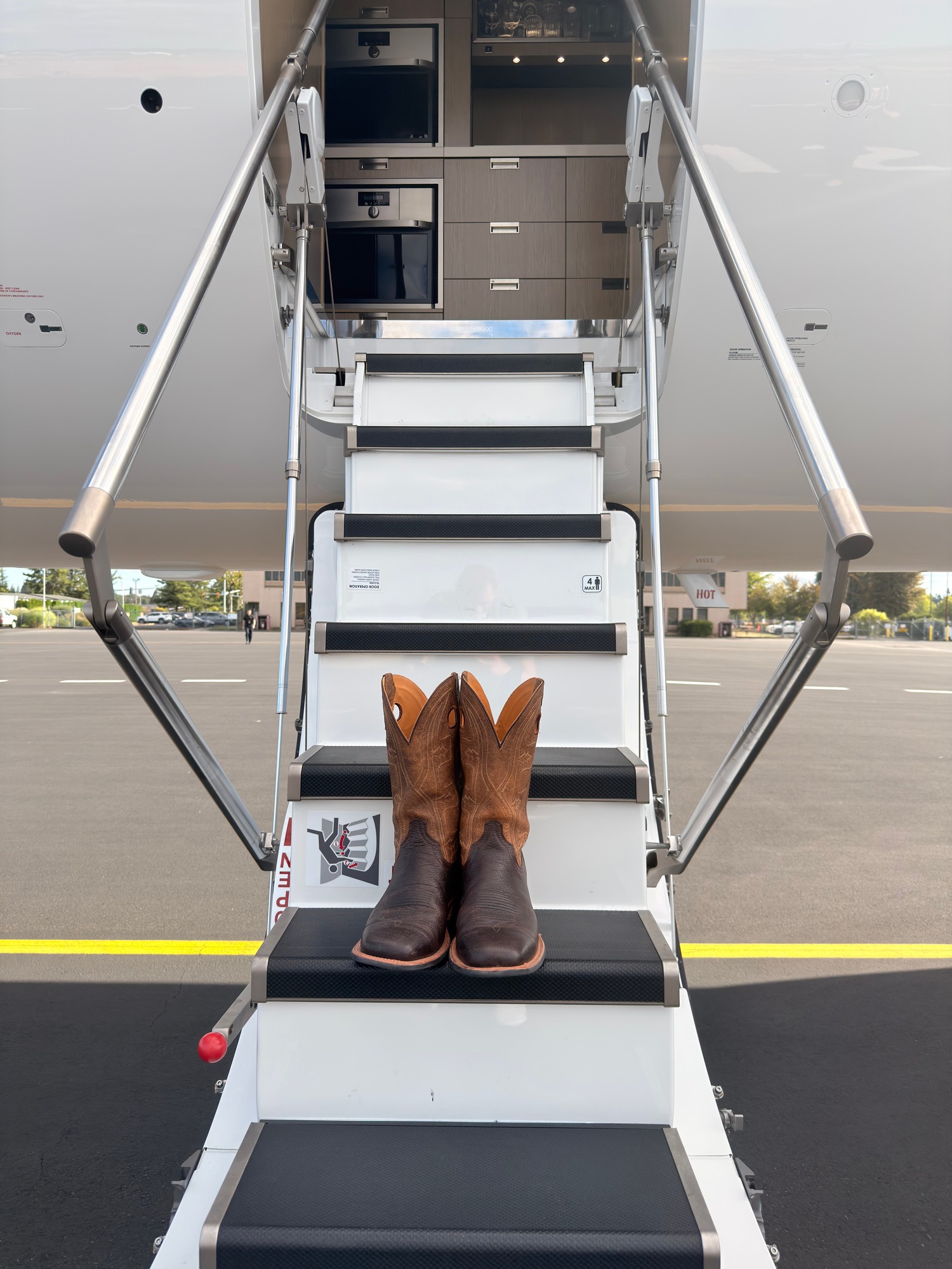 Cowboy boots on the boarding stairs of a private aircraft